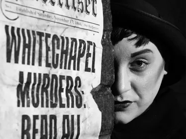 Jack the ripper with half of his face hidden behind a pillar