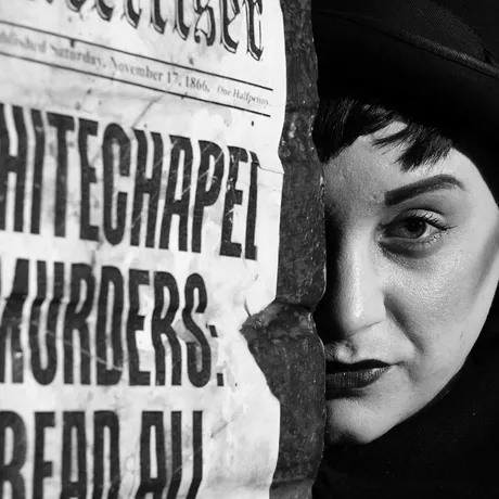 Jack the ripper with half of his face hidden behind a pillar